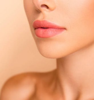 Profile side view cropped close up photo of dreamy sweet well-groomed lady with her shoulder she isolated on pastel beige background stand half turn to camera focus on lips
